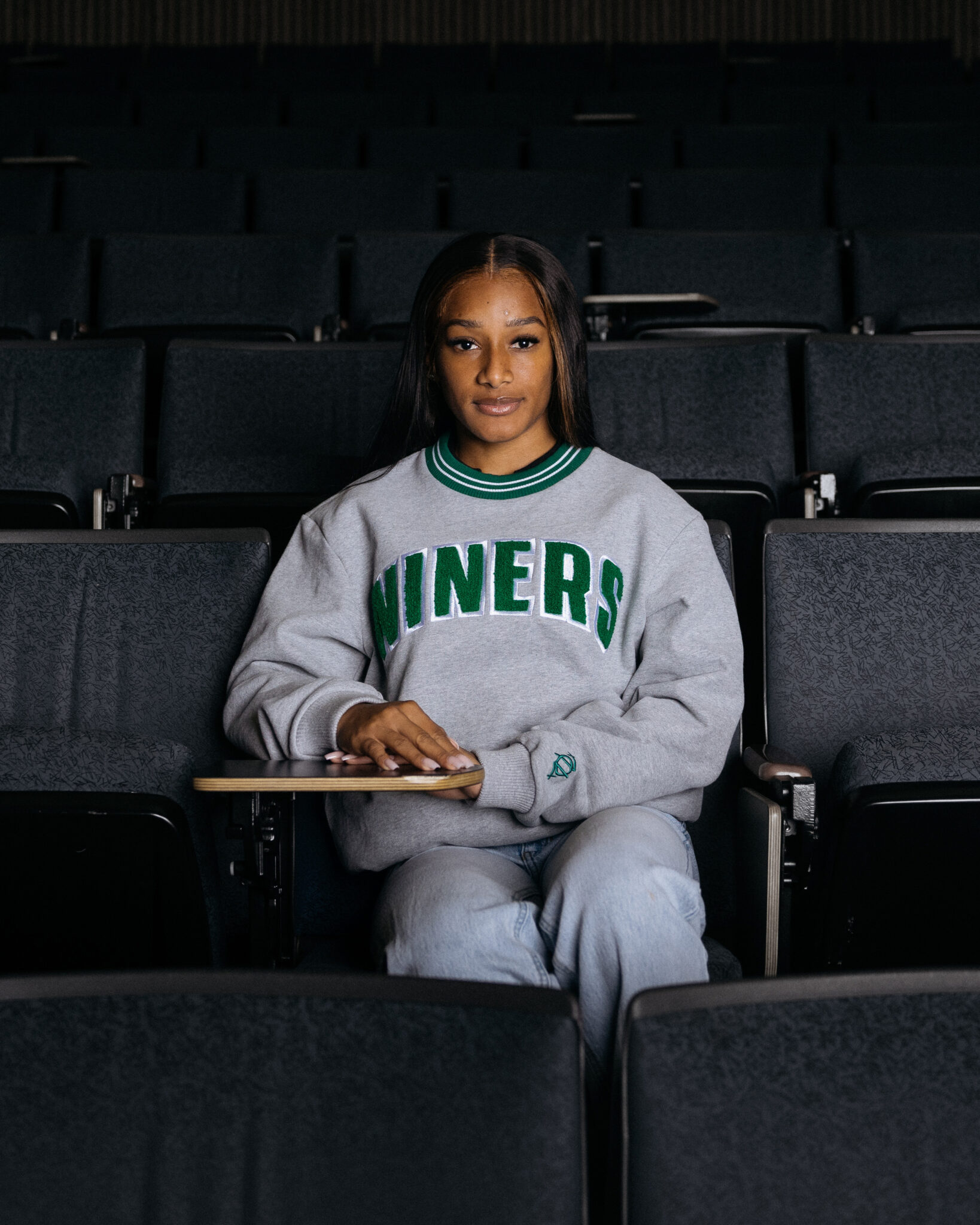 Student in lecture hall wearing a Niners sweatshirt.